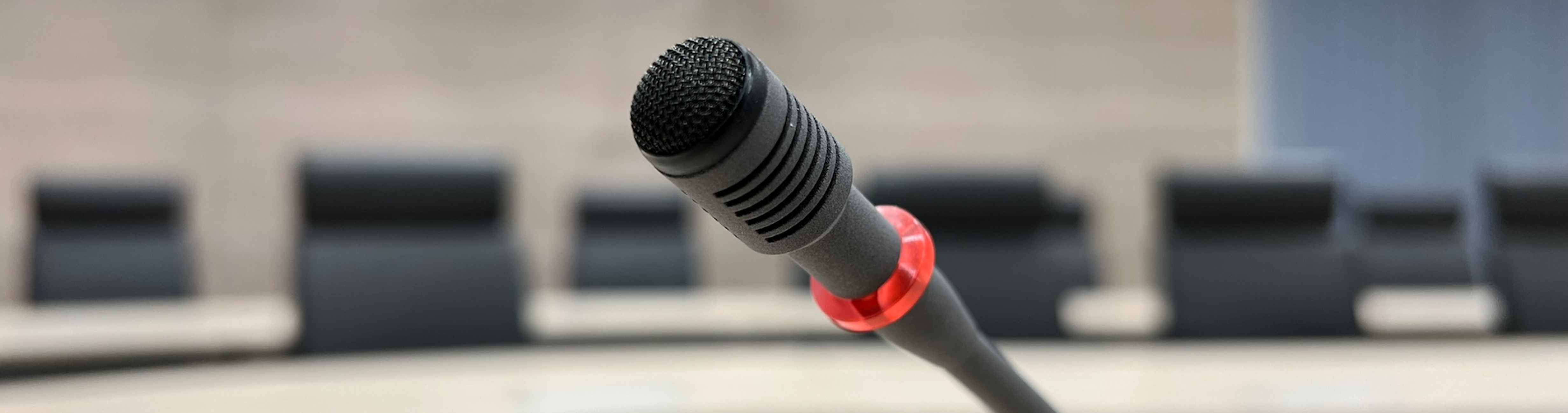 Symbolbild: Mikrofon einer Diskussionsanlage im Ratssaal